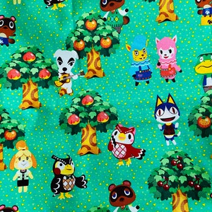 May include: A green fabric with a repeating pattern of animal characters from the Animal Crossing video game. The characters include Tom Nook, Isabelle, and other villagers. The fabric also features trees with fruit and cherries.