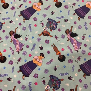 May include: A blue fabric with a repeating pattern of cartoon characters. The characters are a woman with long black hair wearing a purple dress, a woman with short black hair wearing a purple dress, and a woman with short black hair wearing a blue dress. The fabric also has a repeating pattern of flowers and leaves.