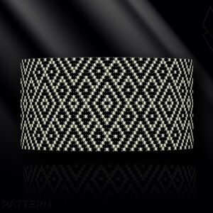 May include: A wide, woven bracelet featuring a geometric diamond pattern in black and cream. The bracelet has a cylindrical shape and appears to be made of beads or small woven threads. The background is black with a subtle gradient.