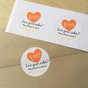 May include: Three round white stickers with an orange heart that says "Etsy" in black text. Each sticker says "Love your order? Please leave a review!" with five yellow stars.