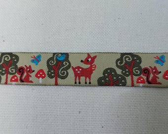May include: Beige ribbon with a repeating pattern of red deer, squirrels, butterflies, and birds in a forest setting. The ribbon has a green and brown color scheme.