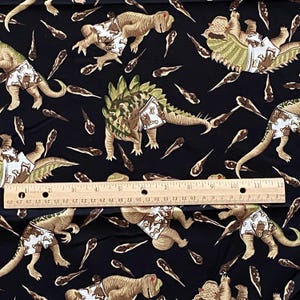 BTY Vintage Dinosaur Toss Fabric Black Quilting Cotton