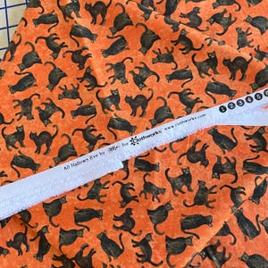 BTY All Hallows Eve Black Cat Toss Fabric Orange Quilting Cotton