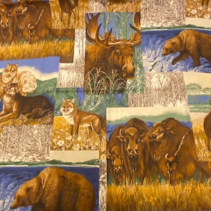 May include: A patchwork fabric featuring various wildlife scenes. The fabric showcases images of moose, bears, wolves, and bison in their natural habitats. The color palette includes shades of brown, green, and blue.