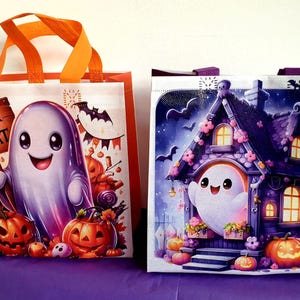 May include: Two Halloween tote bags. One shows a smiling ghost with a "Trick or Treat" sign, pumpkins, and sweets. The other depicts a ghost in a haunted house with bats and pumpkins. Both bags have orange or purple handles.