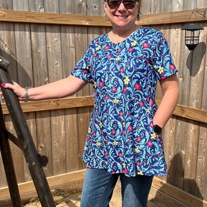 Tunic length top with pockets. Blue with red yellow flower print regular and plus size