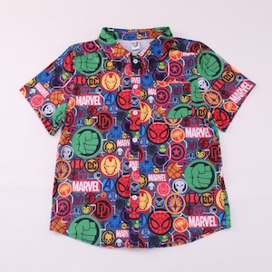 May include: A short-sleeved button-down shirt with a colorful all-over print of Marvel superhero logos and symbols. The shirt is blue with red, yellow, green, and black accents.