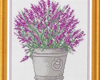 May include: A cross-stitch embroidery of a bouquet of purple flowers in a gray pot with a decorative handle. The flowers are arranged in a vase and are surrounded by a white background.