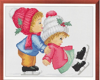 May include: Two children, one wearing a red hat and the other a white hat, are ice skating. The child in the red hat is helping the other child to skate.