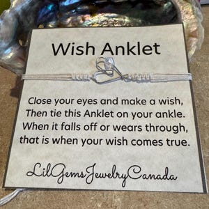 May include: A white card with black text that reads "Wish Anklet". The card also includes instructions on how to use the anklet: "Close your eyes and make a wish, Then tie this Anklet on your ankle. When it falls off or wears through, that is when your wish comes true." The card is signed "Lil Gems Jewelry Canada".