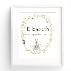 May include: A white framed print with a green wreath, a rabbit holding a basket, and the text "Elizabeth Set apart for God."
