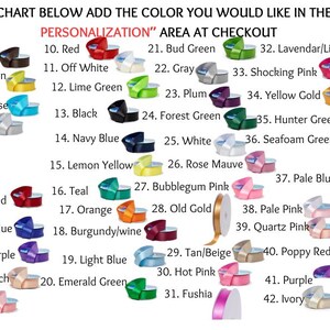 May include: Color chart with 42 ribbon color options, including Brown, Red, and Black. Each color is displayed with a sample ribbon and a corresponding number. Text prompts to add the color choice in the personalization area at checkout.