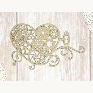 May include: A laser-cut wooden heart with a steampunk design. The heart is filled with gears and other mechanical elements. A key and decorative flourishes extend from the heart. The wood has a natural, light brown color.