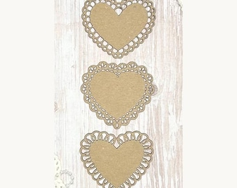 May include: Three heart-shaped paper cutouts with intricate lace-like edges. The hearts are a light brown color and are arranged vertically against a light wood-grain background. Decorative craft supplies.