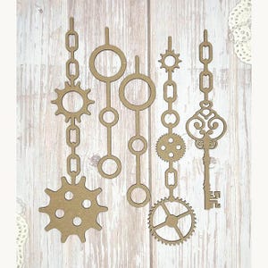 May include: A collection of laser-cut wooden steampunk-themed embellishments. The set includes gears, chains, circles, and a decorative key. The items are light brown and arranged against a light wood grain background.