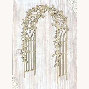 May include: A wooden archway with intricate cut-out details. The arch features a lattice design and is adorned with delicate leaf and vine patterns. The structure is made of light-colored wood and stands on a light wood background.