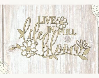 May include: Wooden sign with the words "Live in Full Bloom" in a cursive font, with floral and leaf accents. The sign is made of light-colored wood and is suitable for home decor.