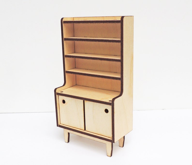 May include: A wooden hutch with a cabinet and open shelves. The hutch is made of light wood with dark brown trim. The cabinet has two doors with a small knob on each door.