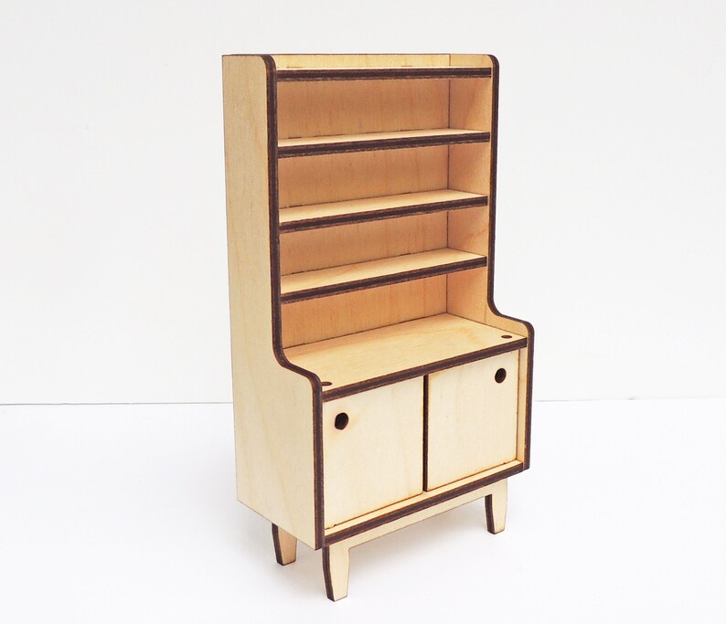 May include: A wooden cabinet with a hutch and two doors. The cabinet has four shelves and is painted in a light wood colour. The doors have a brown trim and a small hole in the centre.