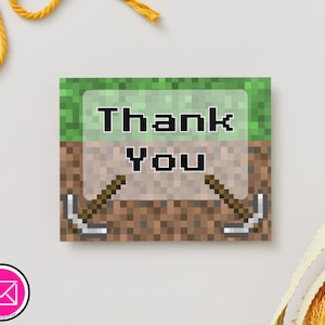 May include: Square thank you card with a pixelated design. The top section is green, the middle is brown, and the bottom is brown. The words "Thank You" are in the center. Two pickaxes are on either side of the words.