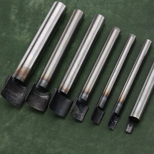 May include: Set of seven metal leather hole punches with different sizes. The punches are silver and have a rounded edge.