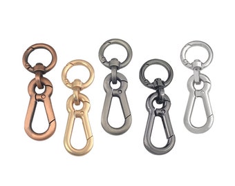 May include: Five metal keychains with a swivel hook and a spring-loaded clasp. The keychains are in different colors: copper, gold, gunmetal, silver, and nickel.