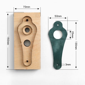 May include: A wooden leather craft punch with a 7.0 inch by 5.9 inch cutting area. The punch has two circles and a teardrop shape. The punch is shown next to a green leather piece that has been cut out using the punch.