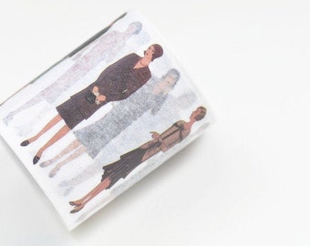 May include: A roll of decorative washi tape featuring illustrations of women in vintage dresses. The figures are depicted in various poses and colors, with a focus on the fashion of the era. The tape is white with a semi-transparent quality.