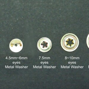May include: Five metal eyelets with star-shaped openings, ranging in size from 2mm to 12mm. The eyelets are arranged from smallest to largest. The eyelets are used for attaching fabric or other materials to a surface. The eyelets are made of metal and have a shiny finish.