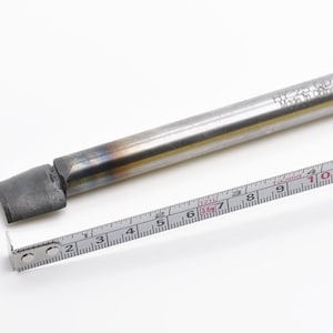 May include: A silver metal rod with a black tip, measuring approximately 10 inches long. The rod has the text "H7-25-00 Made in China" engraved on it. A measuring tape is placed next to the rod.