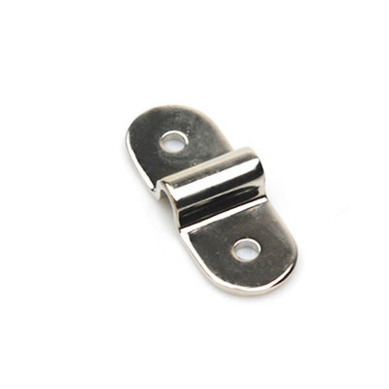May include: Silver metal hook with two holes on each side. The hook is designed to be attached to a surface and has a curved shape to hold an object.