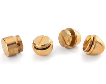 May include: Four gold-toned metal screw-on caps with a flat top and a threaded base.
