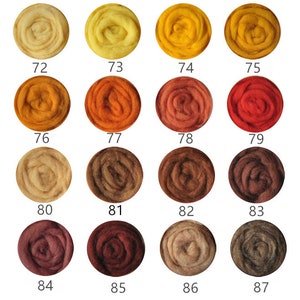 May include: A collection of 16 wool roving samples in shades of yellow, orange, brown, and red. The samples are arranged in four rows of four, with each sample labeled with a number from 72 to 87.