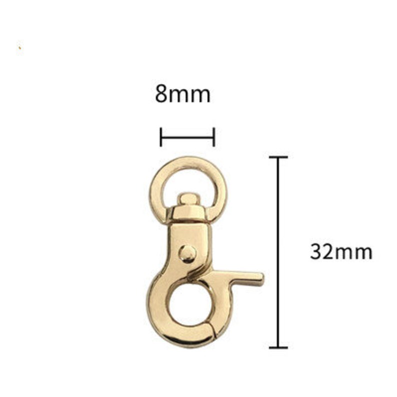 May include: Gold-toned metal swivel clasp with a 32 mm length and 8 mm width. The clasp has a spring-loaded gate and a D-ring.