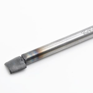 May include: A silver metal tool with a flat, angled tip and a cylindrical handle. The handle is marked with the text "HY-23 GD Made in China".