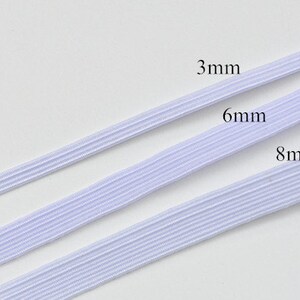 May include: Three white elastic bands of different widths: 3mm, 6mm, and 8mm. The bands are laid out horizontally on a white surface.