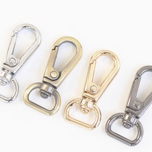 May include: Four metal swivel clasps in different finishes: silver, gold, brass, and black.