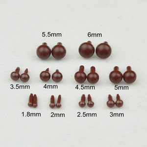 May include: Assortment of brown plastic safety eyes in various sizes, ranging from 1.8 mm to 6 mm. The eyes are ideal for craft projects, such as stuffed animals, dolls, and other plush toys.