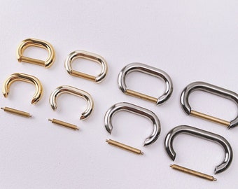 May include: Three sets of metal D-rings with a spring-loaded closure. Each set includes two D-rings and a connecting bar. The D-rings are available in gold, silver, and nickel finishes.