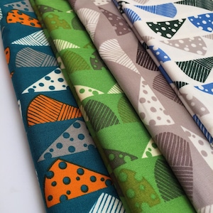 May include: Four fabric swatches with geometric patterns. The swatches are teal, green, grey, and white with black polka dots. The patterns are made up of triangles and semi-circles.