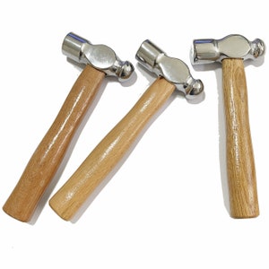 May include: Three wooden-handled ball-peen hammers with silver heads.