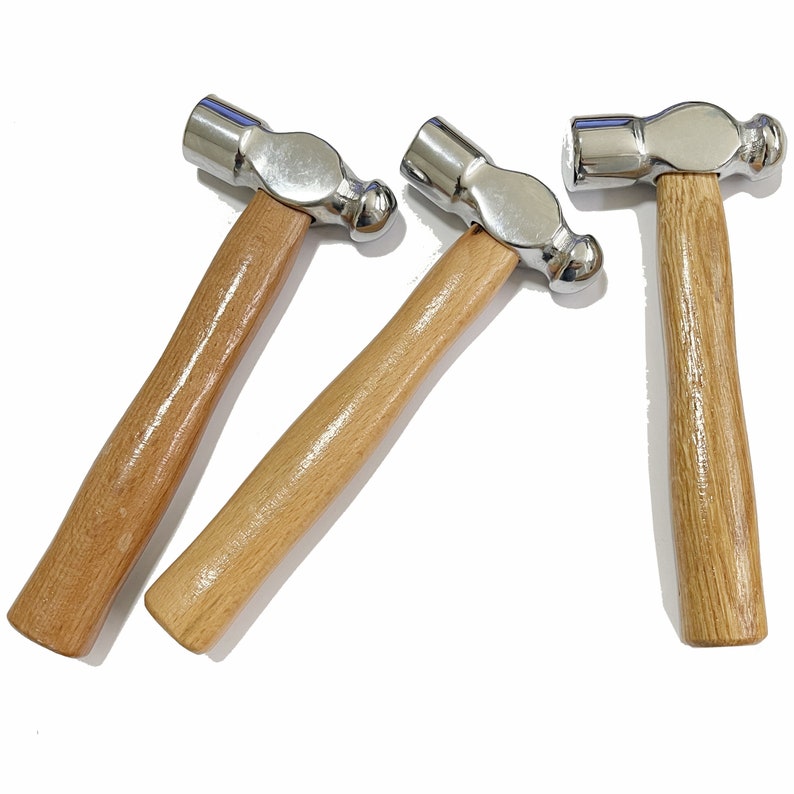May include: Three wooden-handled ball-peen hammers with silver heads.