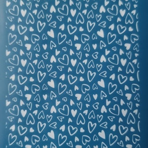 May include: A blue background with a white pattern of hearts of different sizes. The text "mokom.r.8" is at the top of the image and the text "mokom" is at the bottom of the image.