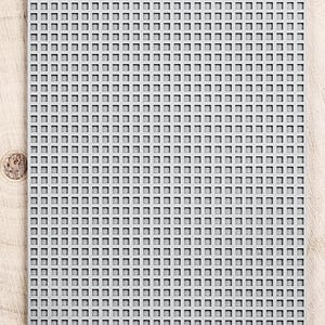 May include: A gray silicone baking mat with a grid pattern. The mat is designed for use in the oven or on the countertop. The mat is made by the company "moiko".