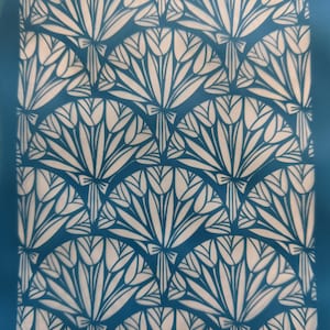 May include: A blue stencil featuring a repeating pattern of white tulip bouquets. The stencil is labelled "Moixom 17.7.28".
