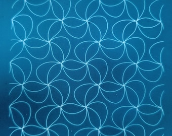 May include: A blue background with a white pattern of overlapping circles forming a flower-like design. The text "moiko 12.37" appears in the top left corner and "moiko" appears in the bottom right corner.