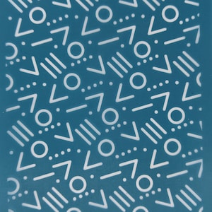 May include: A teal blue background with a repeating pattern of white circles, triangles, and lines. The pattern is abstract and geometric.