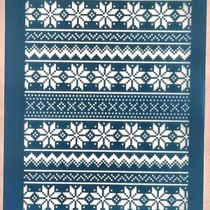 May include: A blue stencil with a white snowflake pattern. The stencil has the text "moiko 19.24" at the top and "moiko" at the bottom.