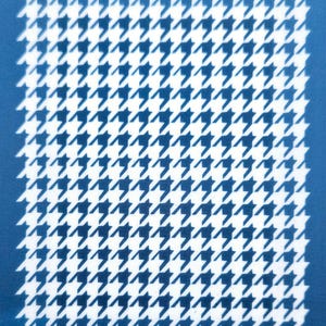 May include: A blue and white houndstooth pattern on a blue background. The pattern is repeated throughout the image. The text "moiko 6.10" appears in the top left corner of the image.