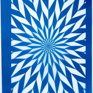 May include: A blue and white geometric stencil with a repeating pattern of sharp, pointed shapes radiating outward from the center. The stencil is labeled "moiko 19.18" in the top left corner and "moiko" in the bottom right corner.